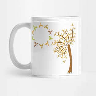 A circle of leaves with a tree of fall leaves. Mug